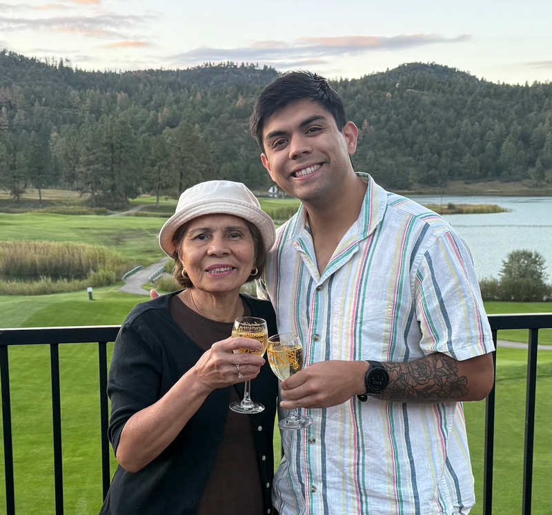 Luke with a family member beside a lake